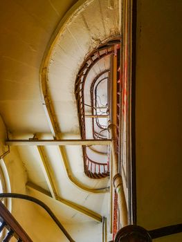 Lookup to spiral staircase in old tenement house