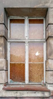 Broken glass in old wooden window of old tenement house in Wroclaw city