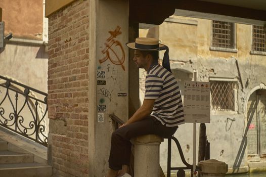 VENICE, ITALY 25 MARCH 2019: Gondolier waiting for customers in Venice
