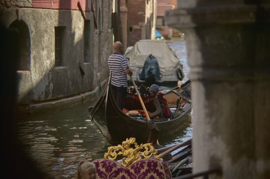VENICE, ITALY 25 MARCH 2019: Gondola in Venice with people on board