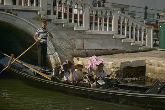 VENICE, ITALY 25 MARCH 2019: Gondola in Venice with people on board