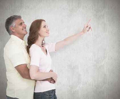 Casual couple hugging and looking against white background