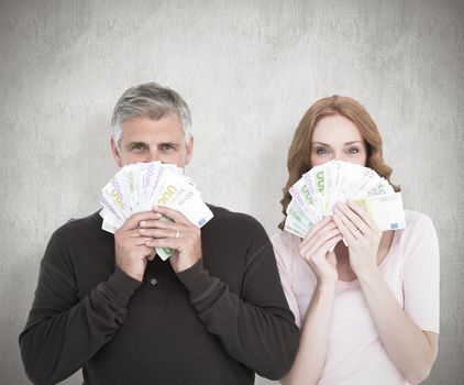Casual couple showing their cash against white background