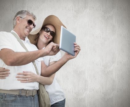 Vacationing couple taking photo against white background