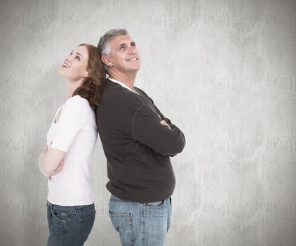 Casual couple smiling and looking up against white background