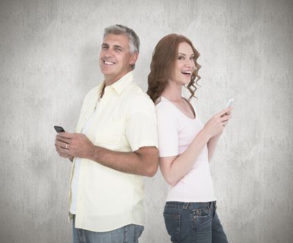Casual couple sending text messages against white background