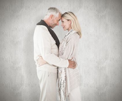 Happy couple standing and hugging against white background