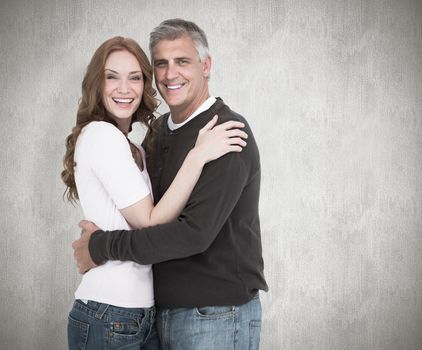 Casual couple smiling at camera against white background