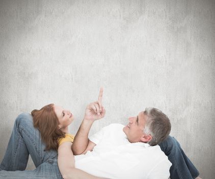 Casual couple lying on floor against white background