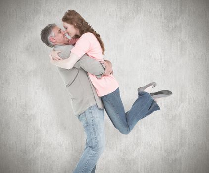 Casual couple hugging each other against white background