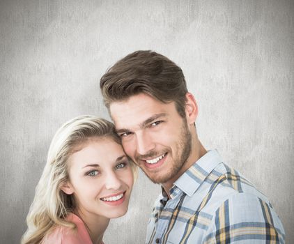 Attractive couple smiling at camera against white background