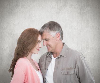 Casual couple hugging and smiling against white background