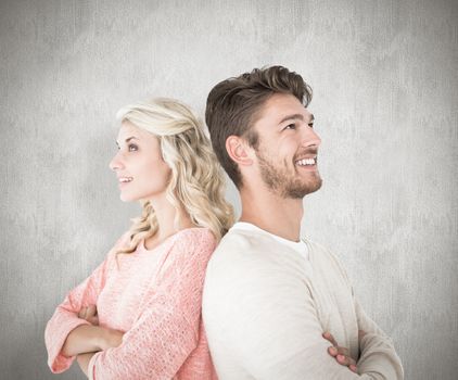 Attractive couple smiling with arms crossed against white background