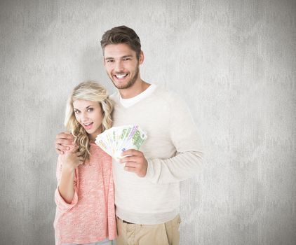 Attractive couple flashing their cash against white background