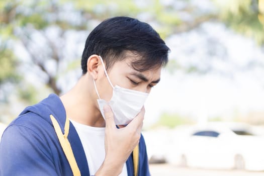 Closeup man wearing face mask for protect air polution or colona virus, health care and medical concept