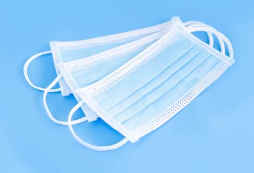Medical mask isolated on blue background for protect air polution or virus covid 19, health care concept