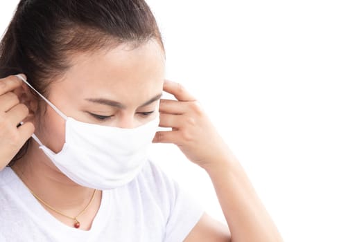 Closeup woman wearing face mask for protect air polution with white background, health care and medical concept