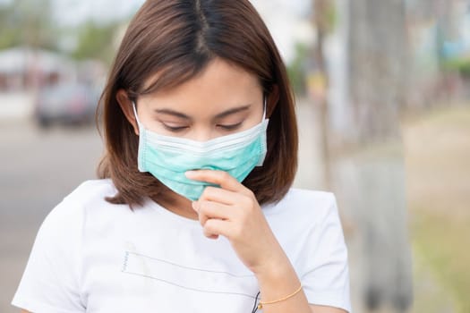 Closeup woman wearing face mask for protect air polution, health care and medical concept