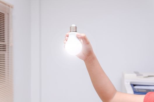 Woman hand holding LED bulb
