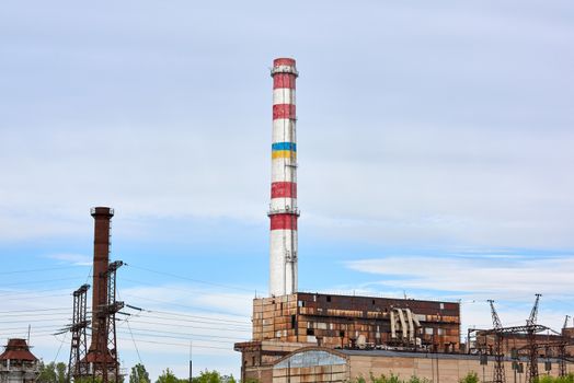 Brick pipe factory against a blue sky, summer day. Kherson, Ukraine