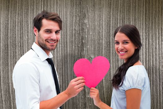 Pretty brunette giving boyfriend her heart against wooden planks