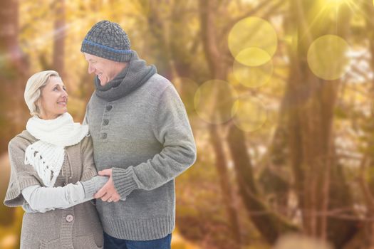 Mature winter couple against tranquil autumn scene in forest