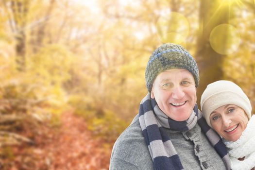 Mature winter couple against tranquil autumn scene in forest