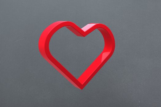 Red love heart against grey