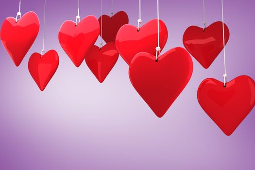 Love hearts against purple vignette