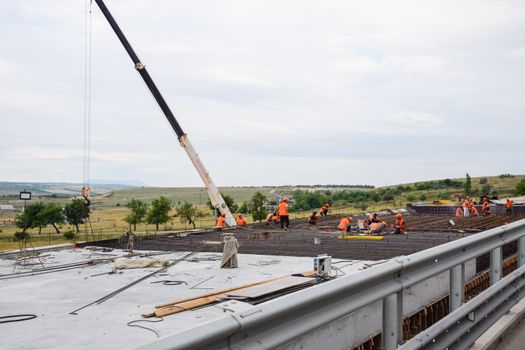 Construction of a new road and transport interchange. Work on reinforced concrete structures and road surface.