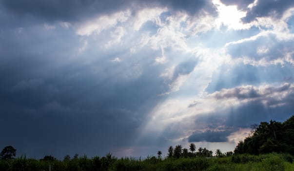 Beam of Sunlight behind dark clouds in the countryside