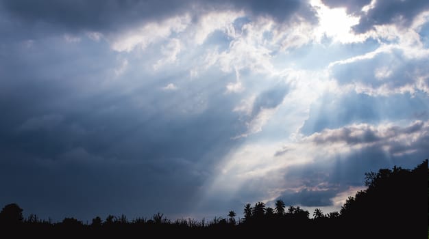 Beam of Sunlight behind dark clouds in the countryside