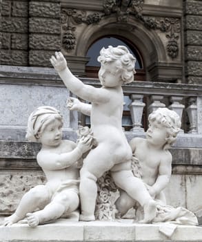 Playing children statue near Hofburg palace in Vienna, Austria