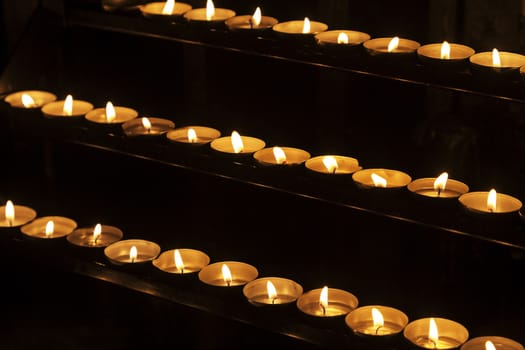 Burning candles in a church, concept of faith