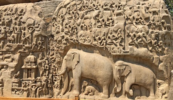 Descent of the Ganges is one of the Group of Monuments at Mahabalipuram and it is a UNESCO World Heritage Site. It is a giant open-air rock cut bas relief sculptures carved on two monolithic rocks. The story depicted in the relief is the descent of the sacred river Ganges to earth from the heavens. The relief was created by Narasimhavarman-1 to celebrate the victory over Chalukiya king. There are 146 sculptures of animals, God, people and half-humans carved in the rock relief.