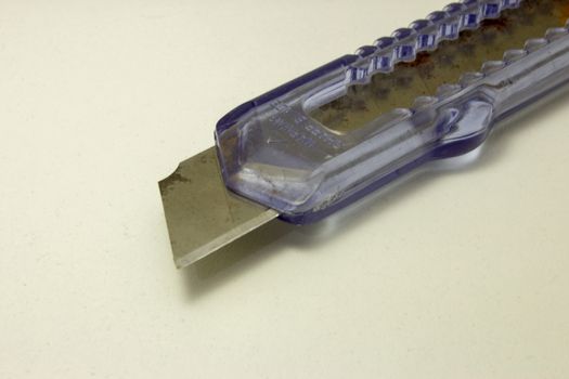 Plastic utility knife with old and rusted blade