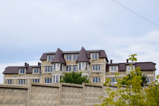 Houses under construction in the suburbs. Construction of new houses and buildings.