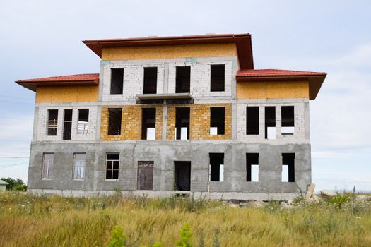 Houses under construction in the suburbs. Construction of new houses and buildings.