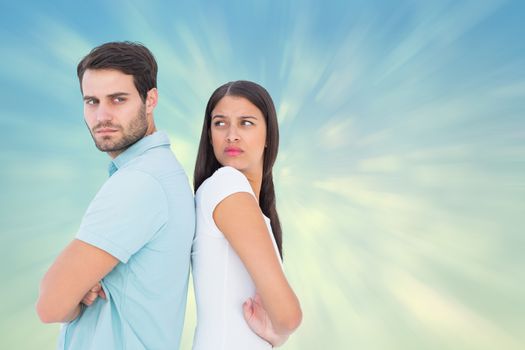 Unhappy couple not speaking to each other  against blue abstract light spot design