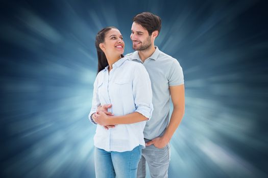 Cute couple embracing and smiling at each other against blue abstract light spot design