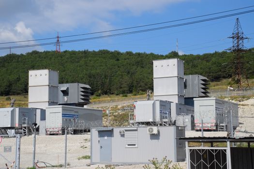 a Power substation equipment, transformers and wire poles.