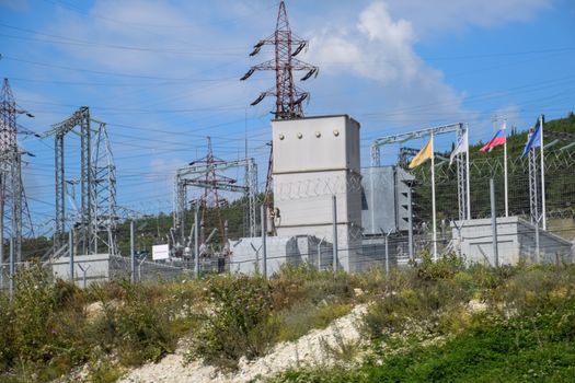 a Power substation equipment, transformers and wire poles.