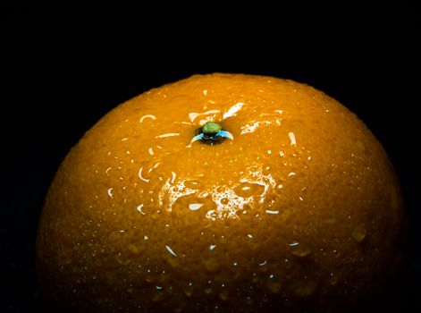 Close-up of Water droplet on glossy surface of freshness freshness orange on black background