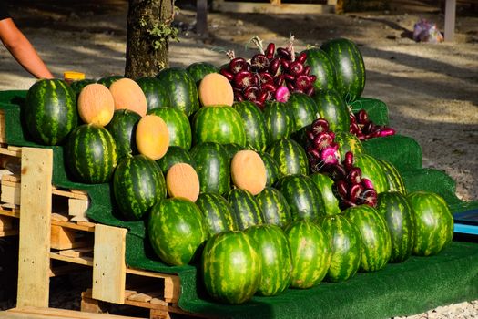 Selling vegetables and watermelons by the road. Resort shops by the road for tourists.