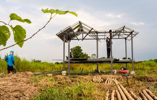 CHONBURI, THAILAND - Oct 12, 2016 Unidentified men work on steel frame of the house is under construction without protective equipment.