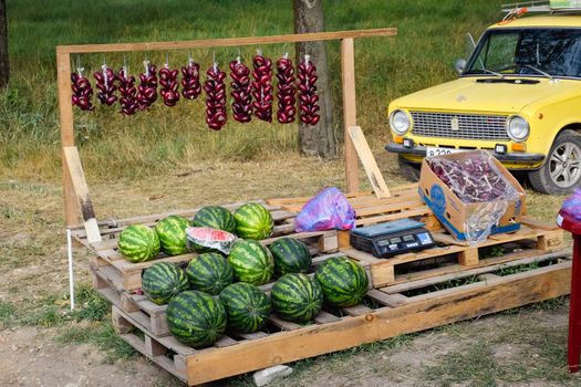 Selling vegetables and watermelons by the road. Resort shops by the road for tourists.