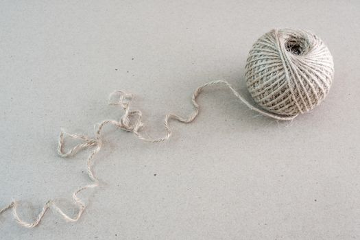 Texture of the brown natural rustic hemp cord in roll on kraft paper texture background