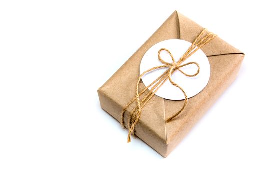 Brown gift box wrapped in kraft paper and rustic hemp cord as natural rustic style with paper for your note