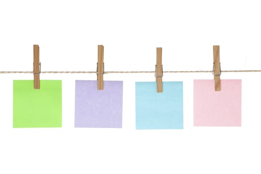 Four colored reminder notes on string line with pegs