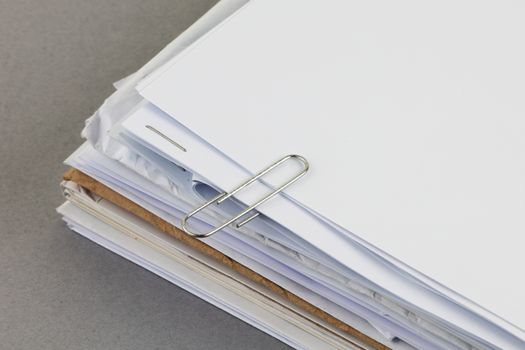 A bundle of work papers with paper clip